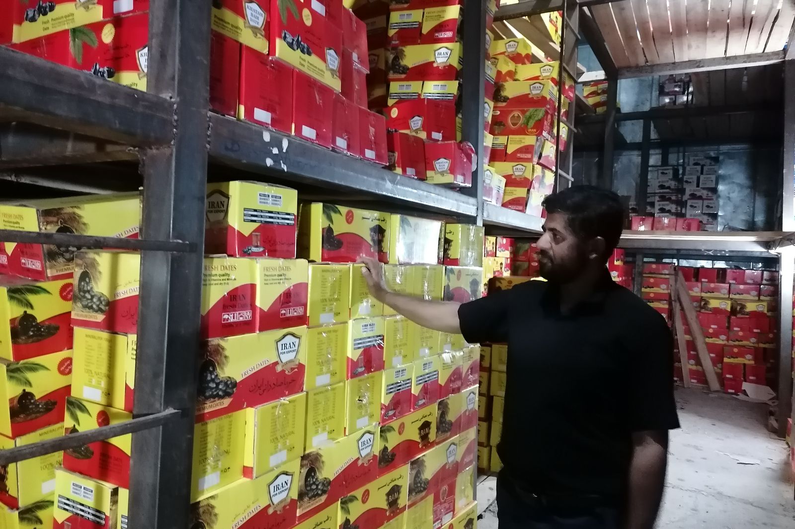 A Nakhl Fanavar representative checking export cartons in cold storage