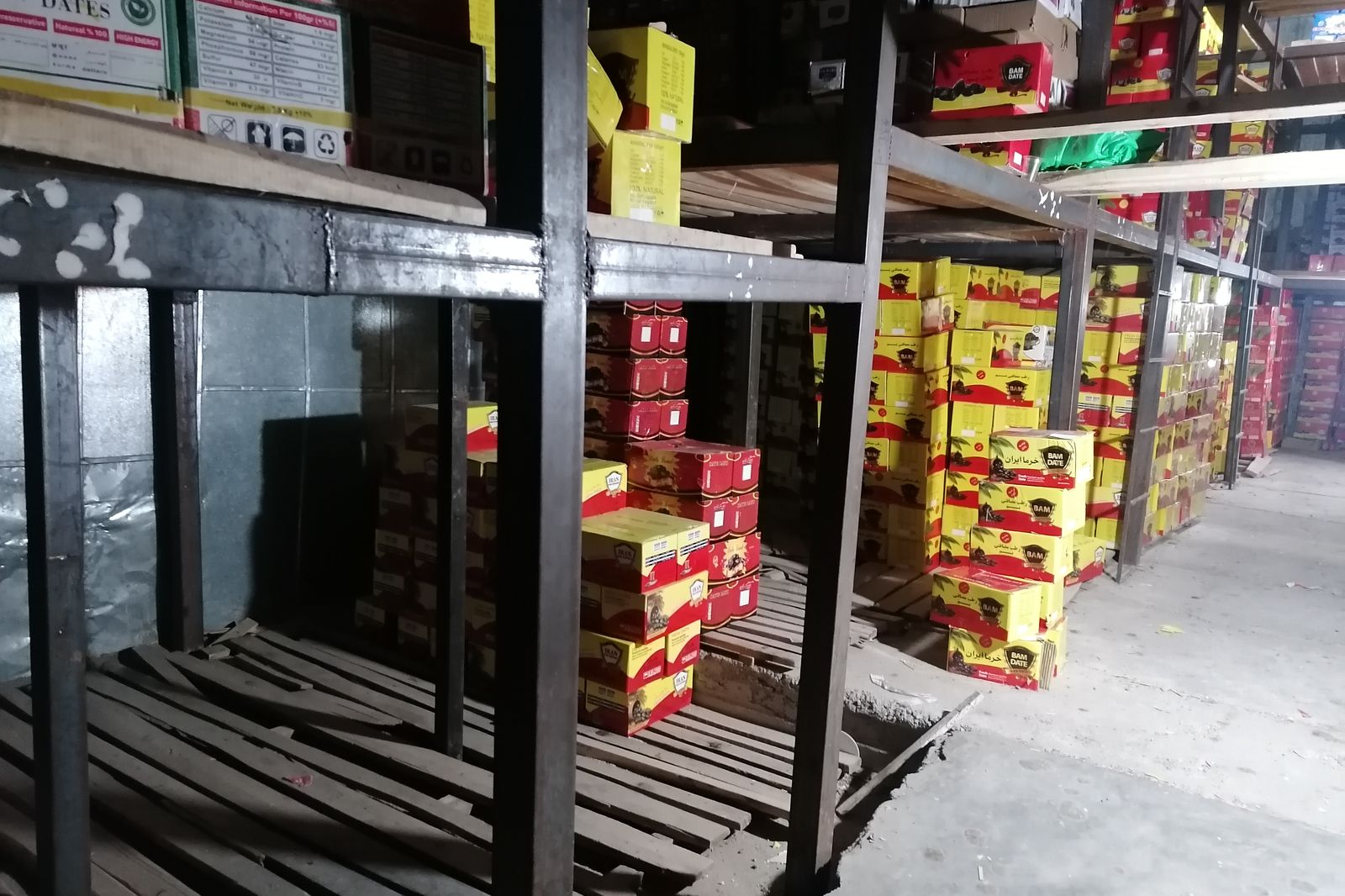 Packed export cartons of Mazafati dates on shelving in Bam
